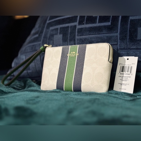 COACH CORNER ZIP WRISTLET IN SIGNATURE
CANVAS WITH VARSITY STRIPE - Picture 1 of 4